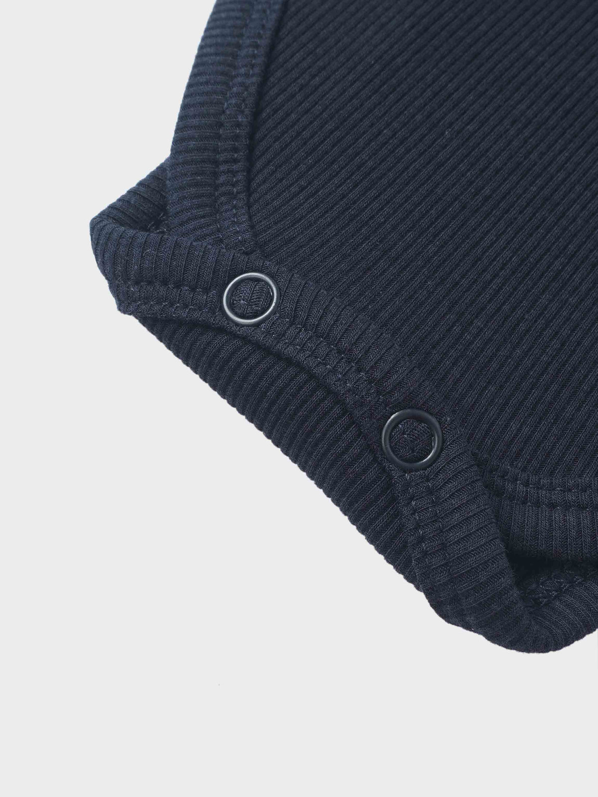 Ribbed mock-neck bodysuit by Adee in navy; unisex dressy top with ribbed knit texture and metal ring accents.