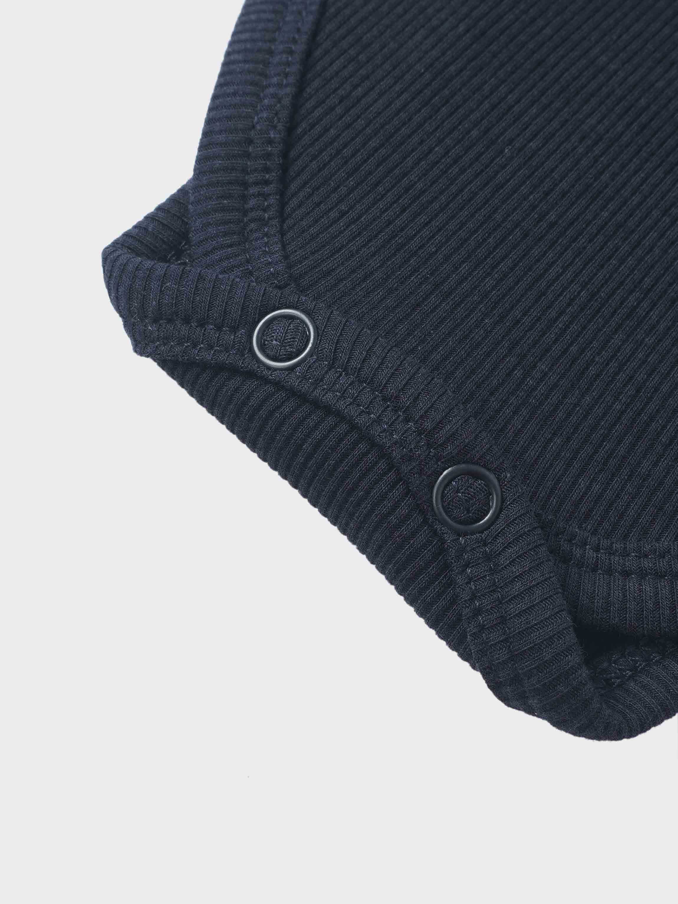Ribbed mock-neck bodysuit by Adee in navy; unisex dressy top with ribbed knit texture and metal ring accents.