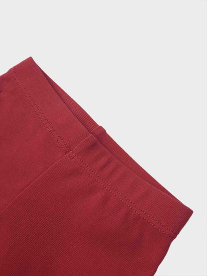 Non Ribbed Leggings - Red; close-up of red fabric with stitched hem detail.