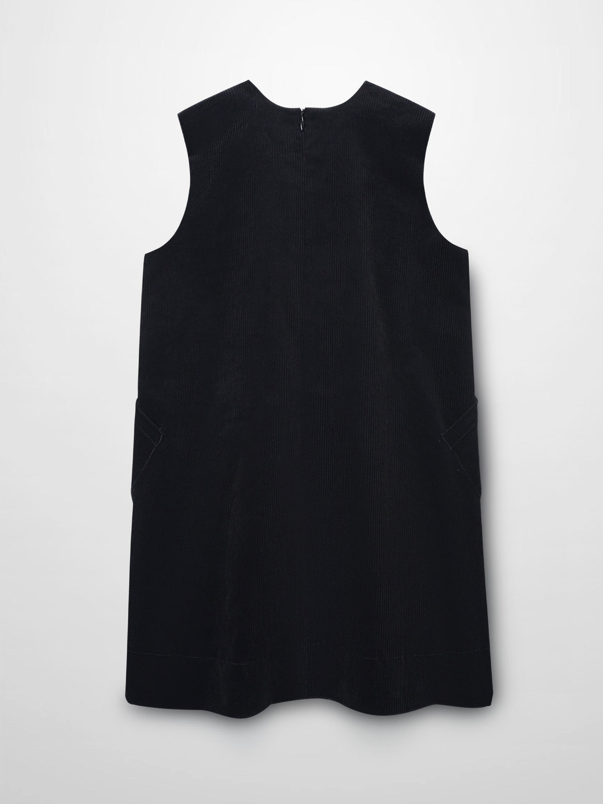 Black corduroy jumper dress with round neckline, A-line silhouette, patch pockets, and hidden back zipper.