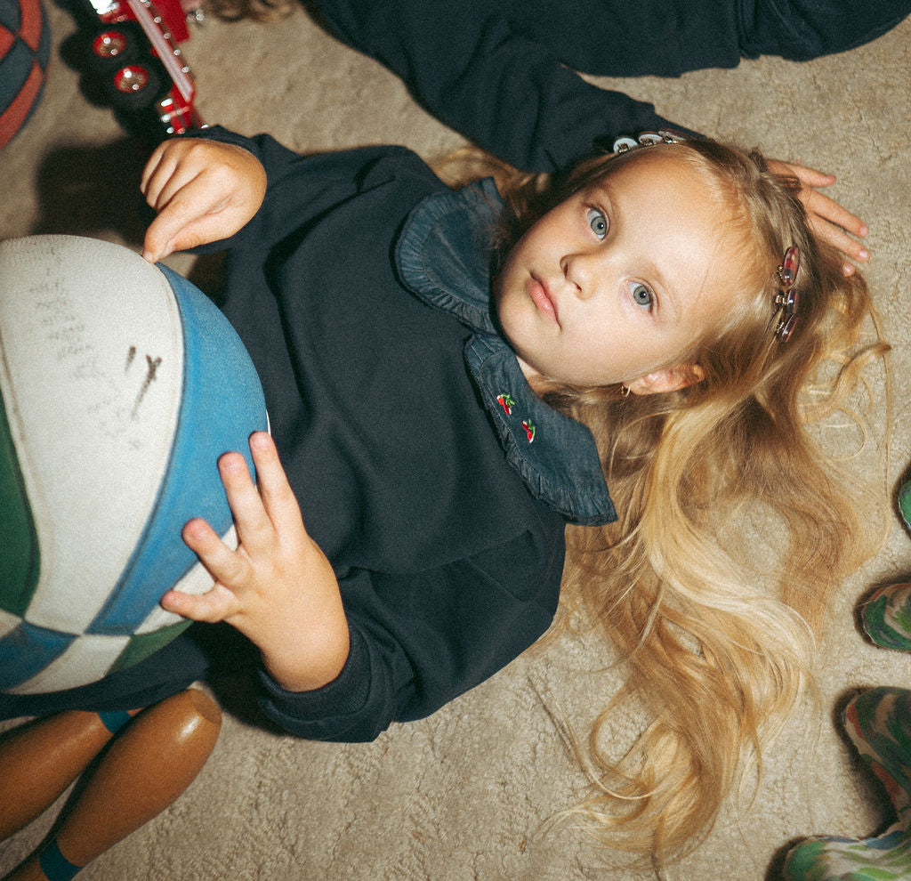 Denim Cherry Collar Sweatshirt for girls; navy blue top with embroidered cherries on the collar.