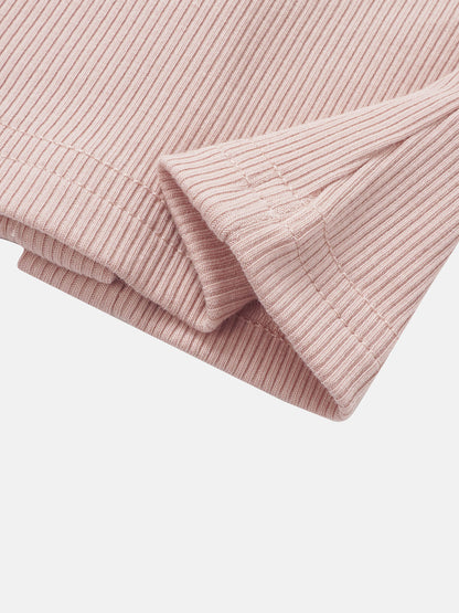 Legacy Stitch Cardigan in light pink ribbed knit, close-up of sleeve cuff.