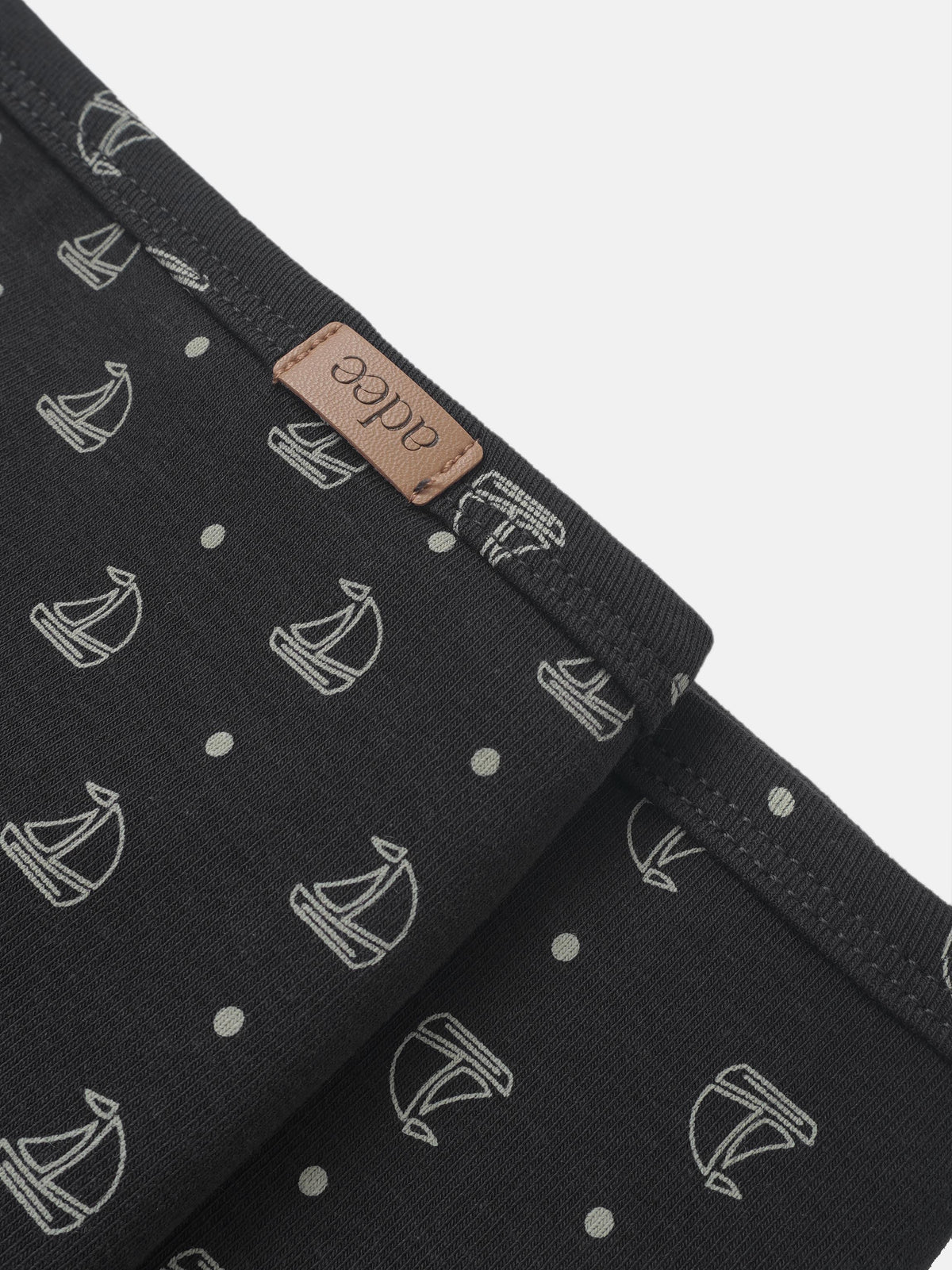 Harbor Dot Blanket by Adee, boys swaddle blanket in navy with light gray sailboats pattern and leather tag.
