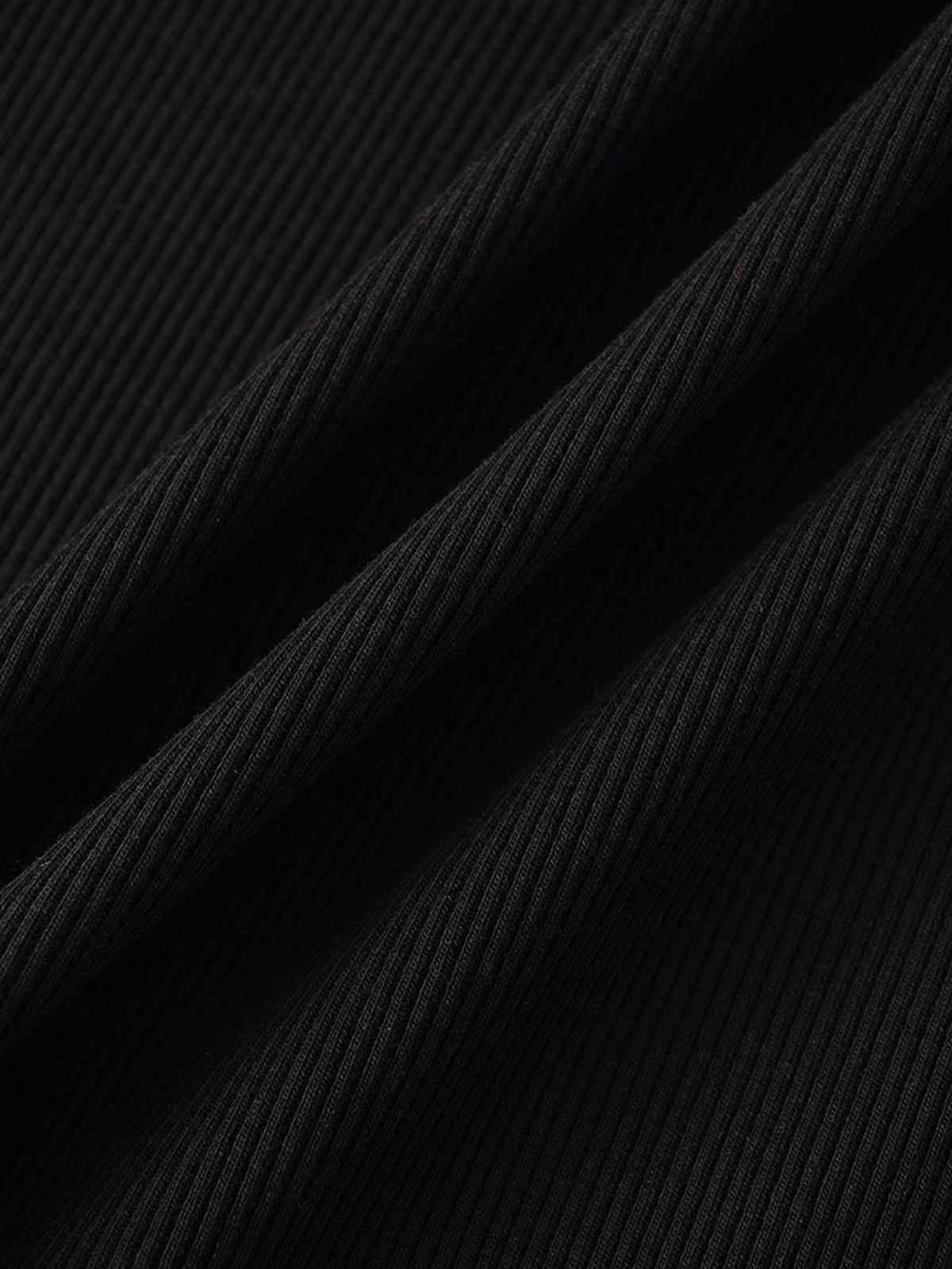 Close-up of black ribbed knit fabric, the soft, lightweight texture of a thin zip hoodie.
