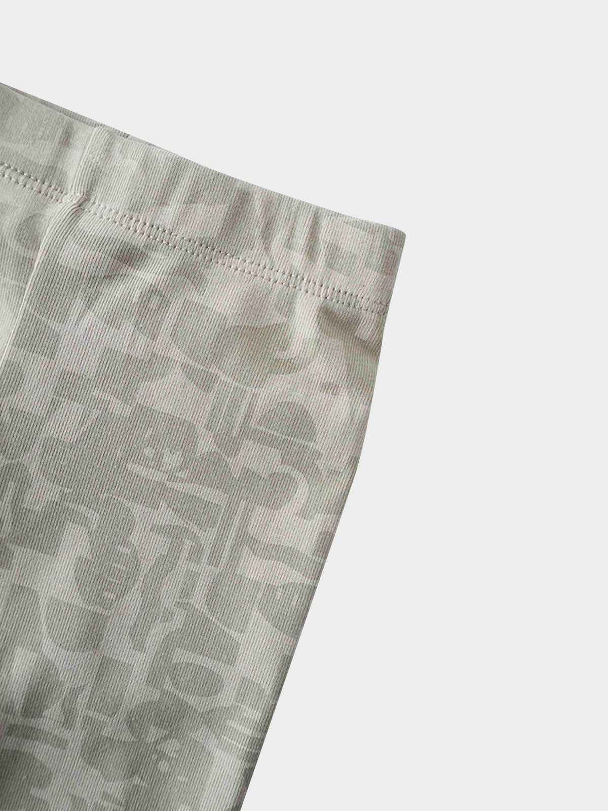 Close-up of Abstract Pajamas-Red fabric with soft neutral abstract shapes and top-stitch seam.