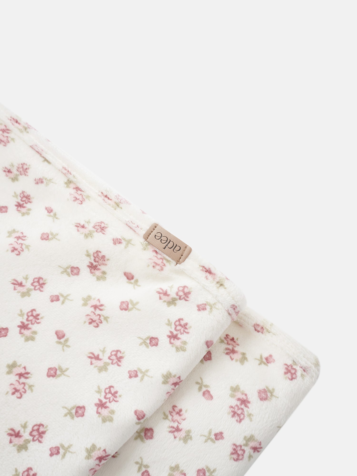 Tiny Blossom Blanket swaddle by Adee, white fabric with pink floral print.