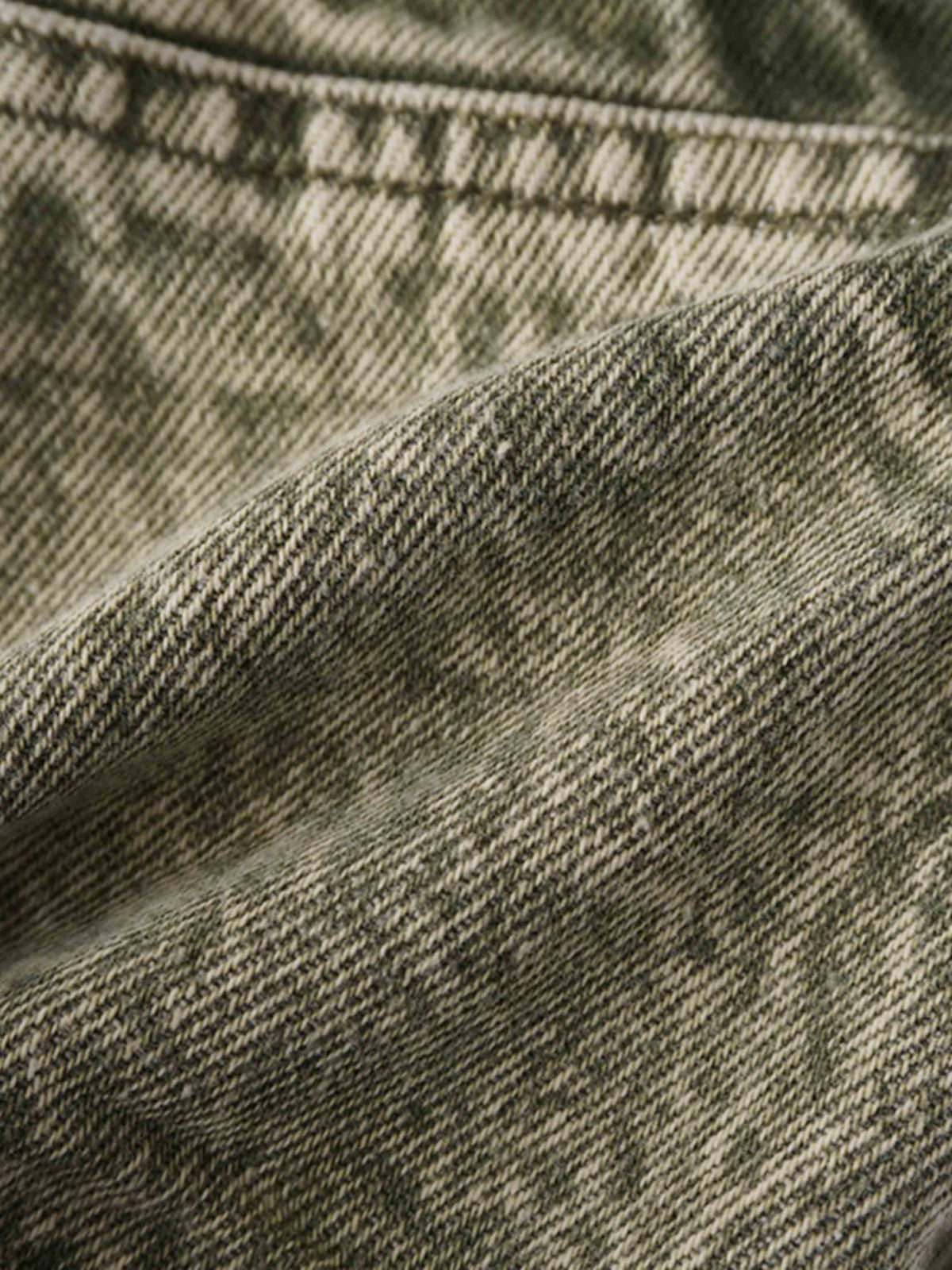 Washed green denim fabric close-up