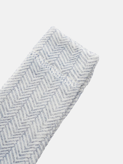 Adee Heritage Herringbone Blue layette set fabric swatch with blue and white chevron pattern.