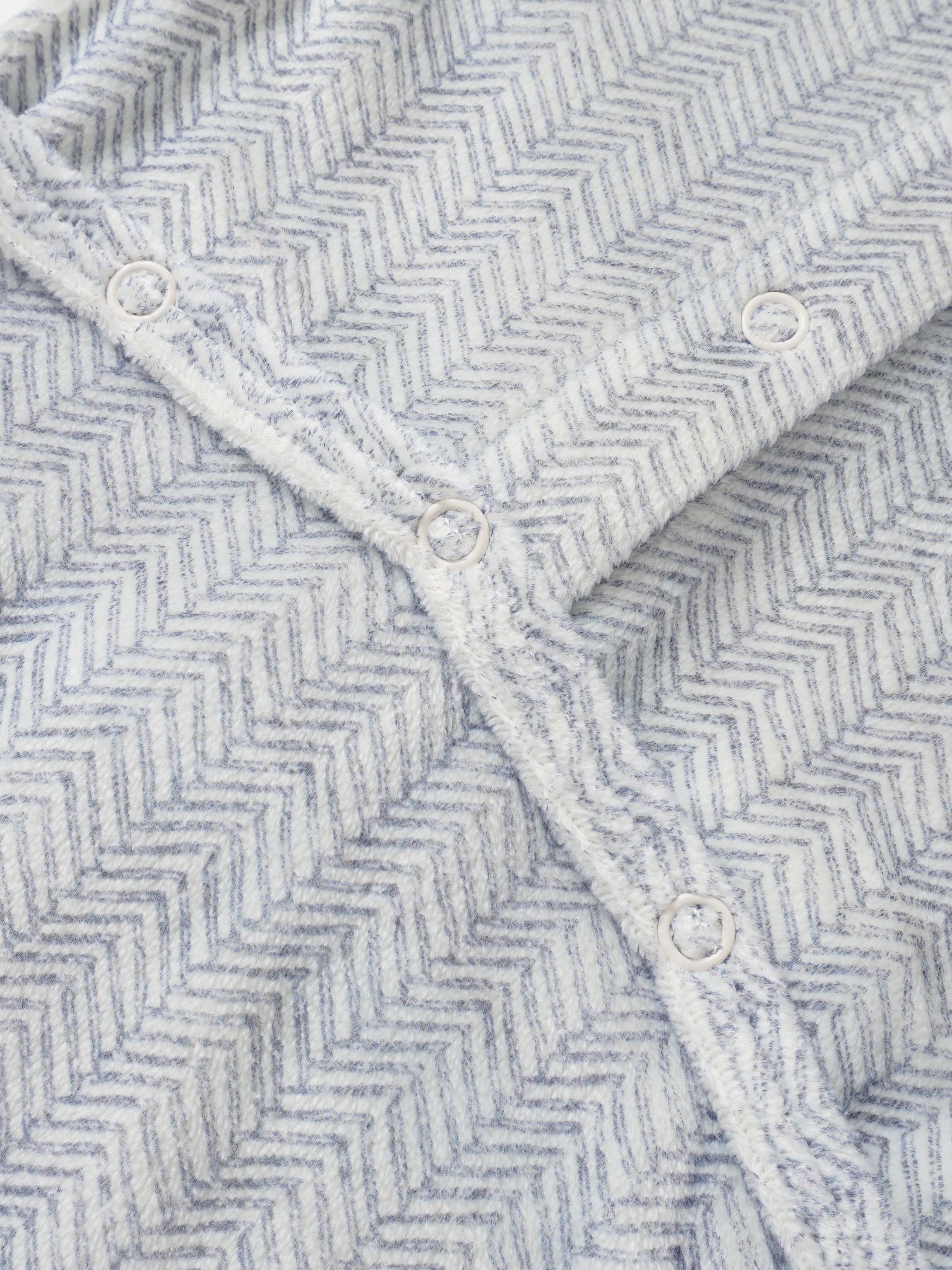 Adee Heritage Herringbone Blue layette blanket for boys with white snap buttons along the edge.