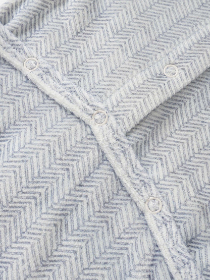 Adee Heritage Herringbone Blue layette blanket for boys with white snap buttons along the edge.