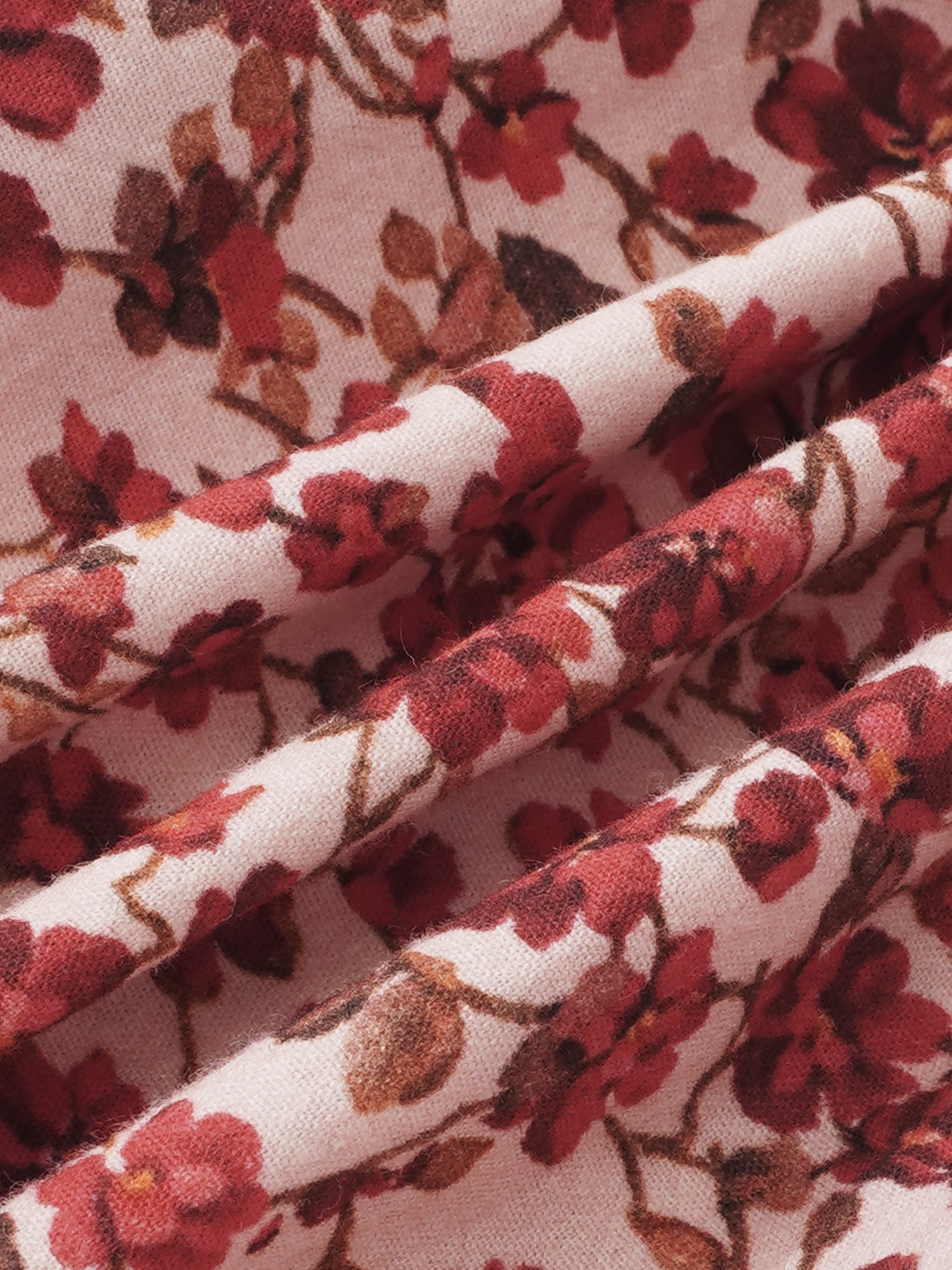 Red flower shirt and bloomers set fabric close-up with pink floral print
