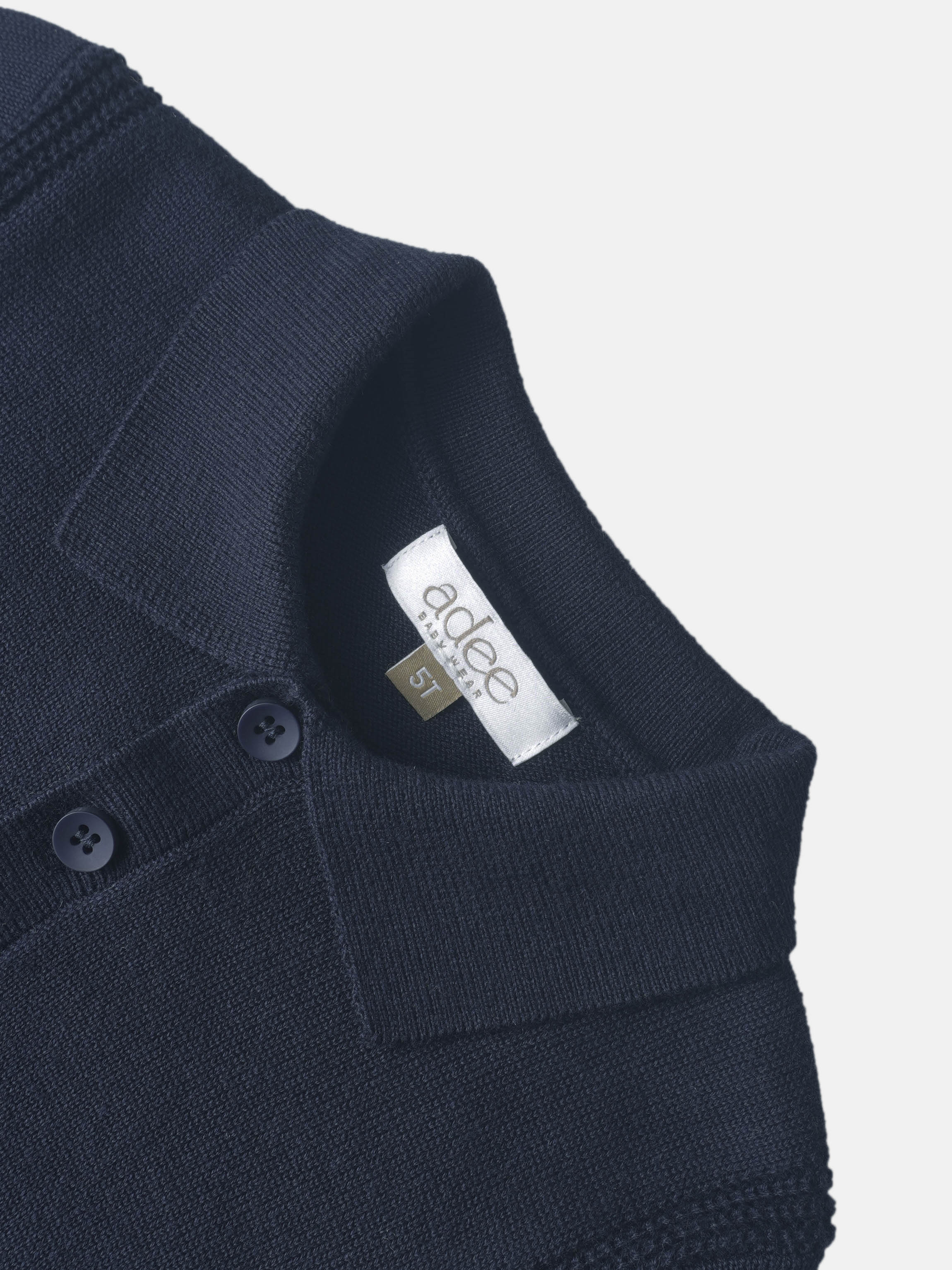 Knit navy sweater for boys, Adee brand dressy top, size 5T, close-up of shoulder with button detail.