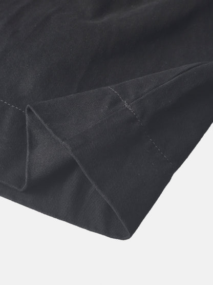 Denim jumper dress for girls in black by Adee; close-up of dark denim fabric and stitching.