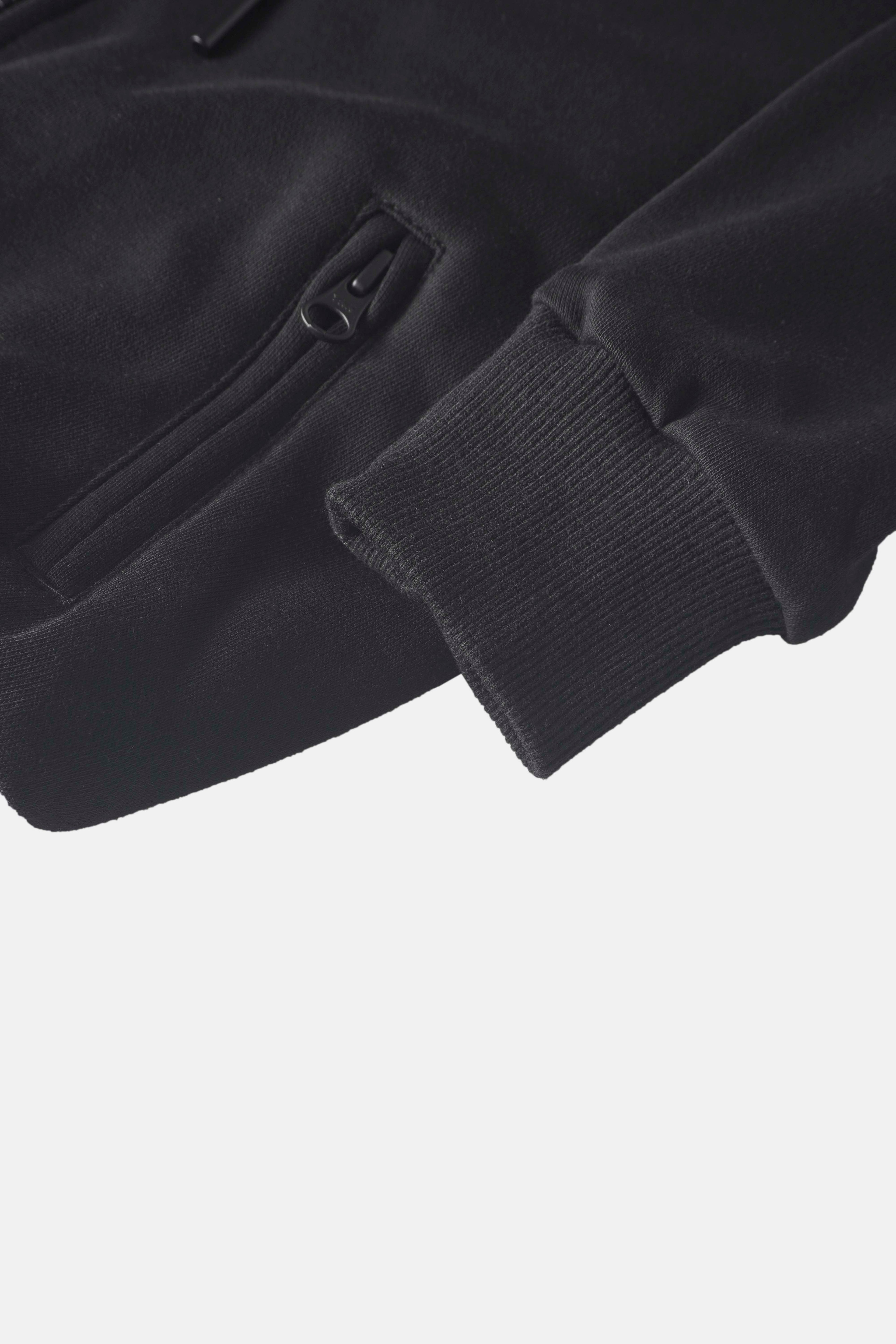 Fur-lined sweatshirt, black; Adee unisex top with zip pocket and ribbed cuffs.