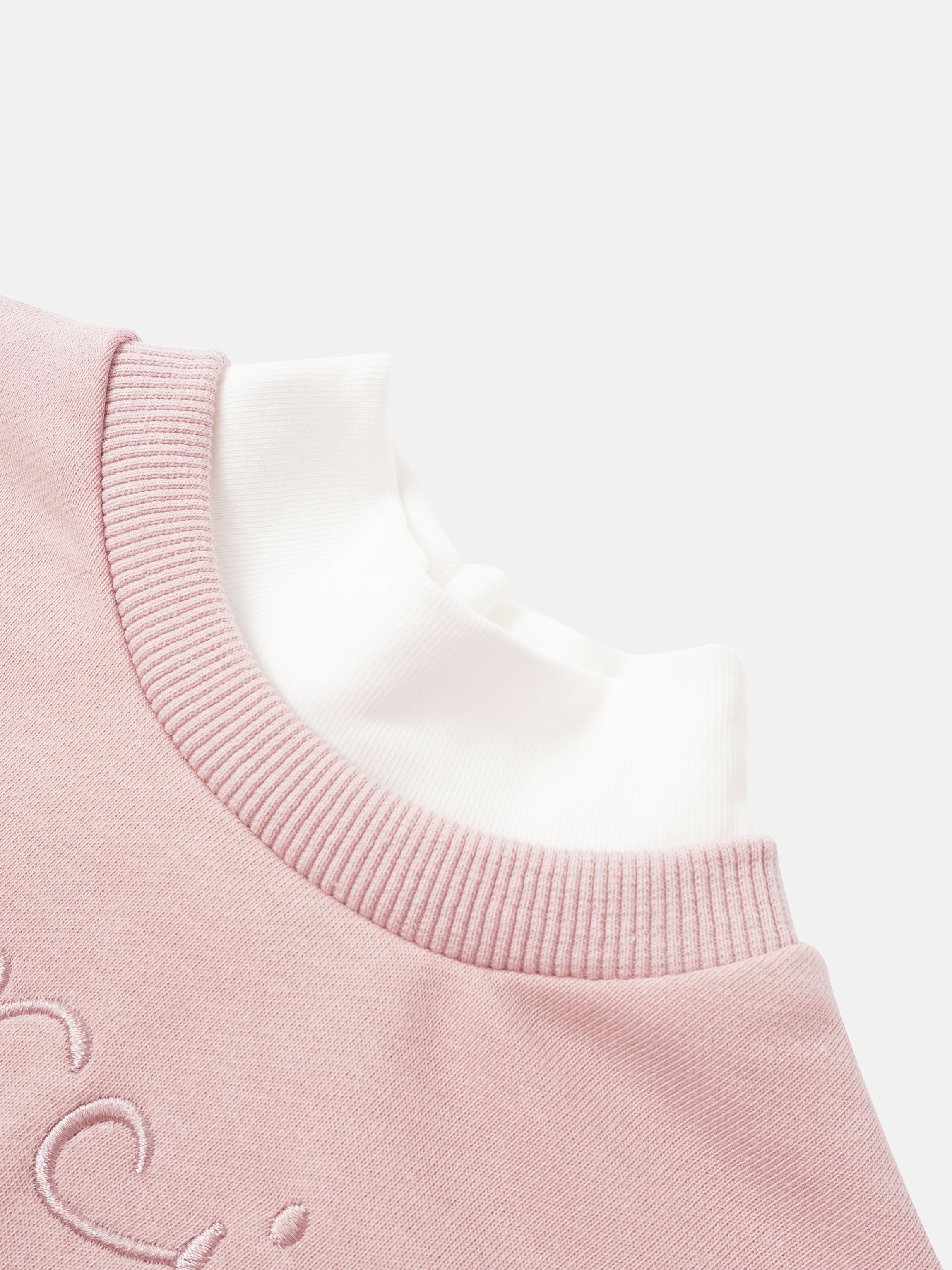 Girls pink contrast mock-neck sweatshirt with white inner collar.