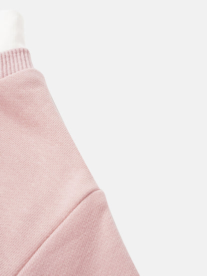 Girls pink contrast mock neck sweatshirt; close-up of rib-knit fabric.