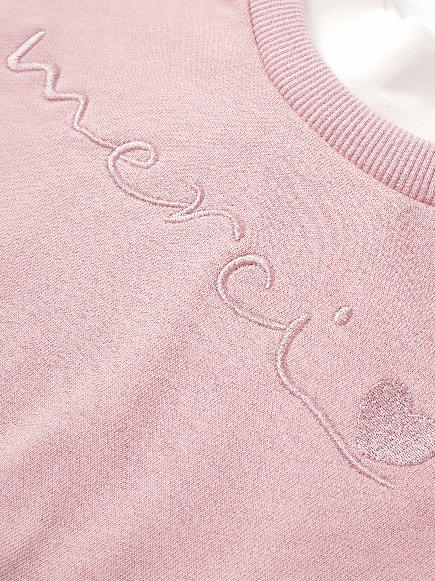 Girls pink Adee contrast mock neck sweatshirt with embroidered script.