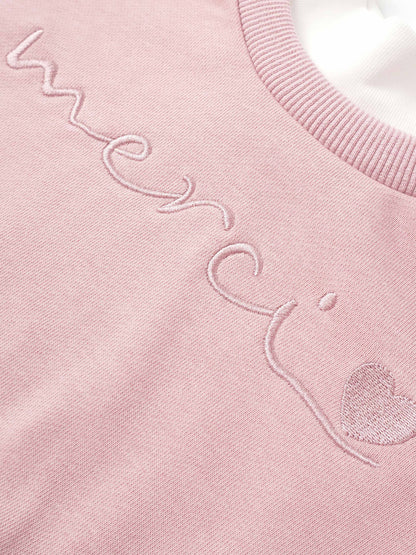 Girls pink Adee contrast mock neck sweatshirt with embroidered script.