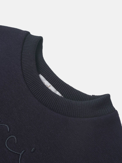 Merci Sweatshirt for boys in navy, Adee brand, close-up of ribbed crewneck and partial embroidery.