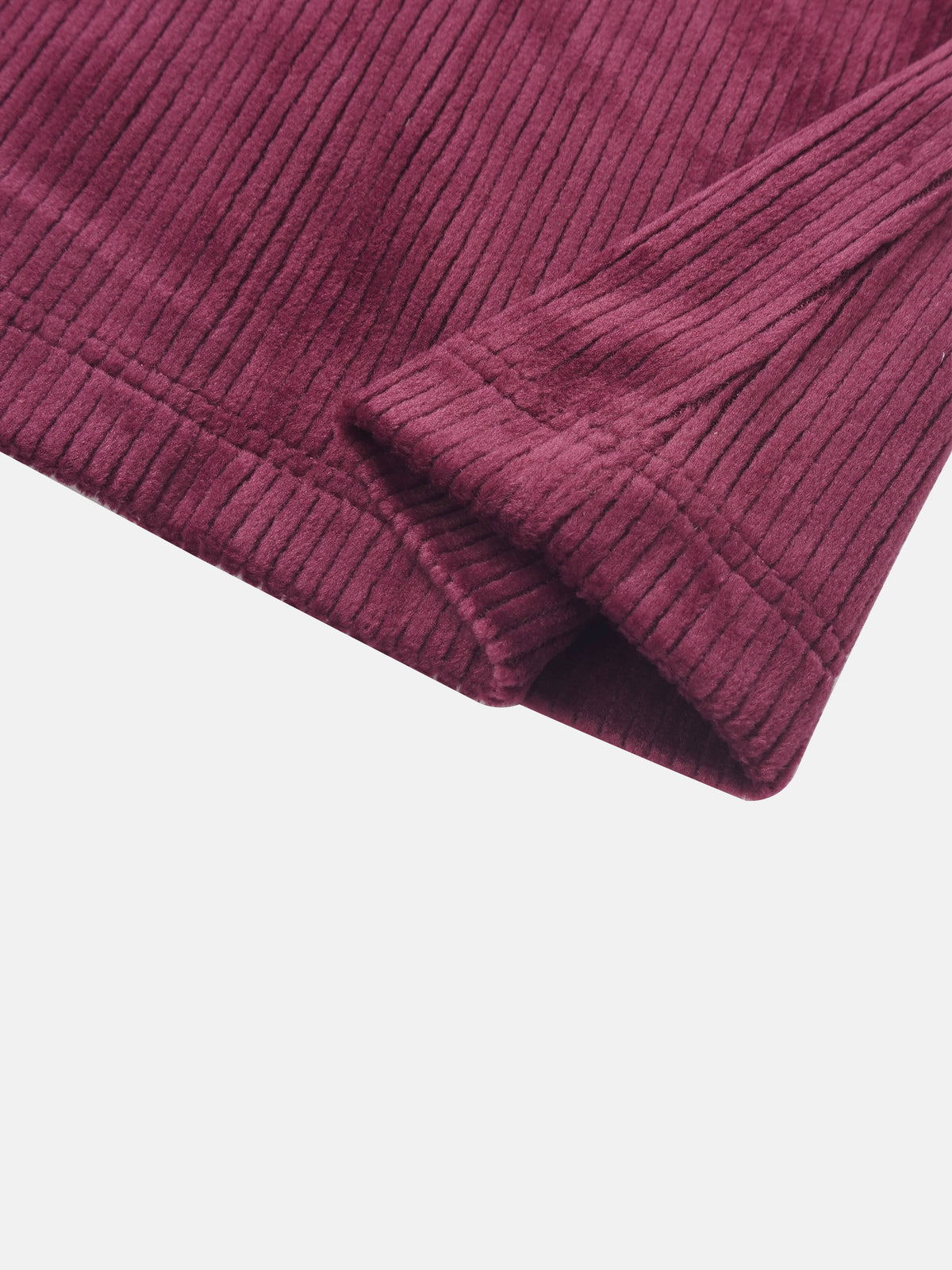 Ribbed velour burgundy girls pajamas fabric close-up with cuff detail.