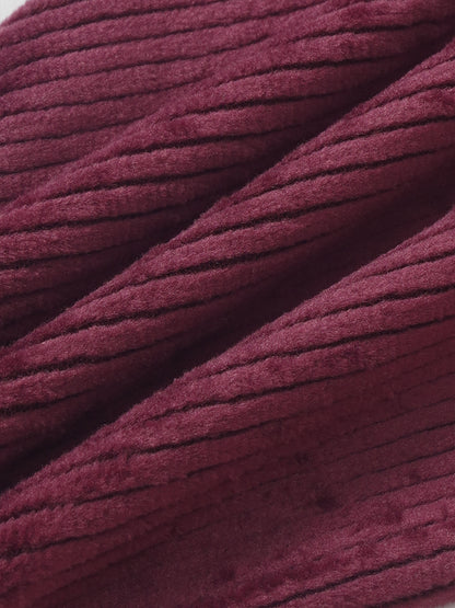Girls burgundy ribbed velour pajamas fabric close-up, plush textured material for comfortable fit and cozy nights