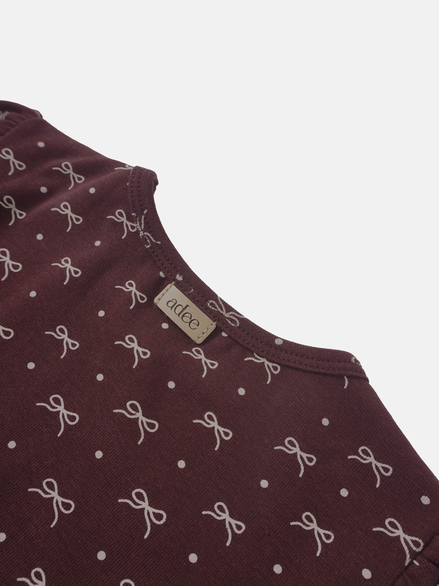 Burgundy Bow T-shirt for girls by Adee with white bow motifs and polka-dot pattern.
