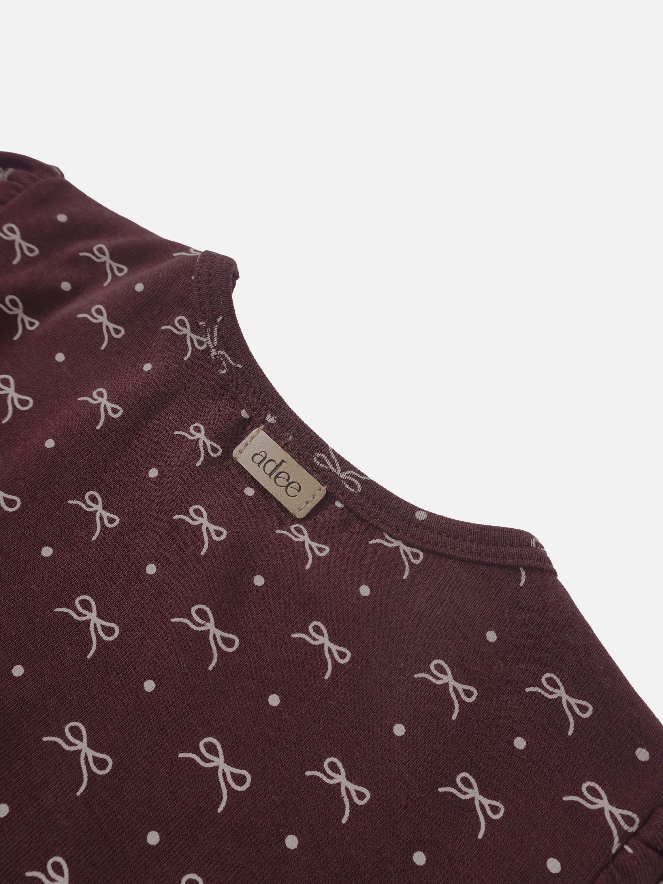 Burgundy Bow T-shirt for girls by Adee with white bow motifs and polka-dot pattern.