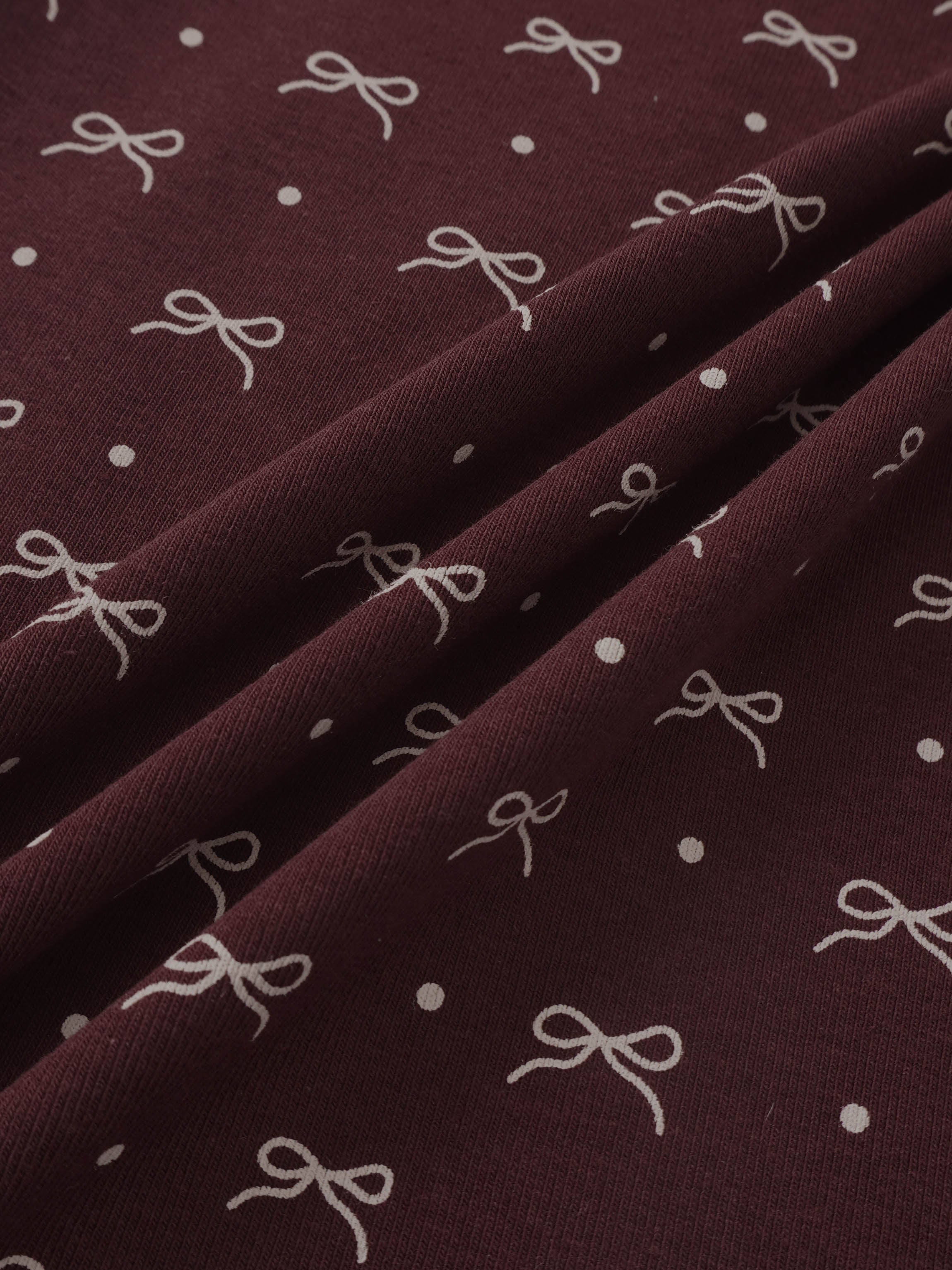 Adee Burgundy Bow T-Shirt for girls; burgundy fabric with white bow motifs.