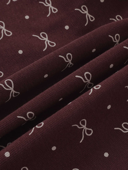 Burgundy Bow Layered Skirt by Adee; close-up of knit fabric with white bow prints and dots.