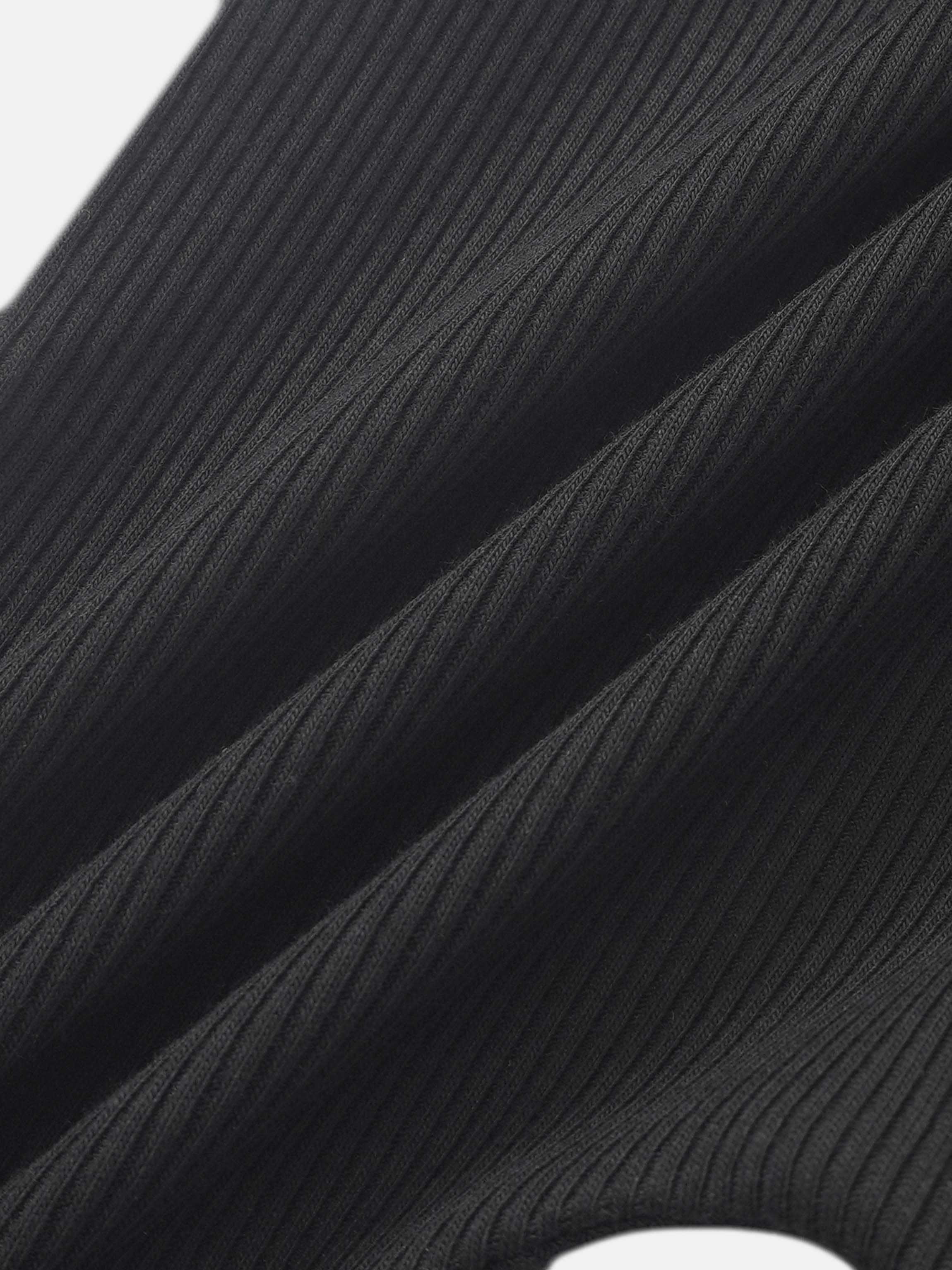 Ribbed overalls by Adee in black; unisex basics fabric close-up