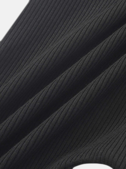 Ribbed overalls by Adee in black; unisex basics fabric close-up