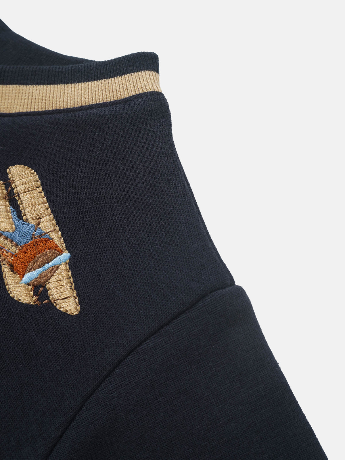 Embroidered Jet Sweatshirt; navy blue boys top with beige ribbed collar and embroidered patch.