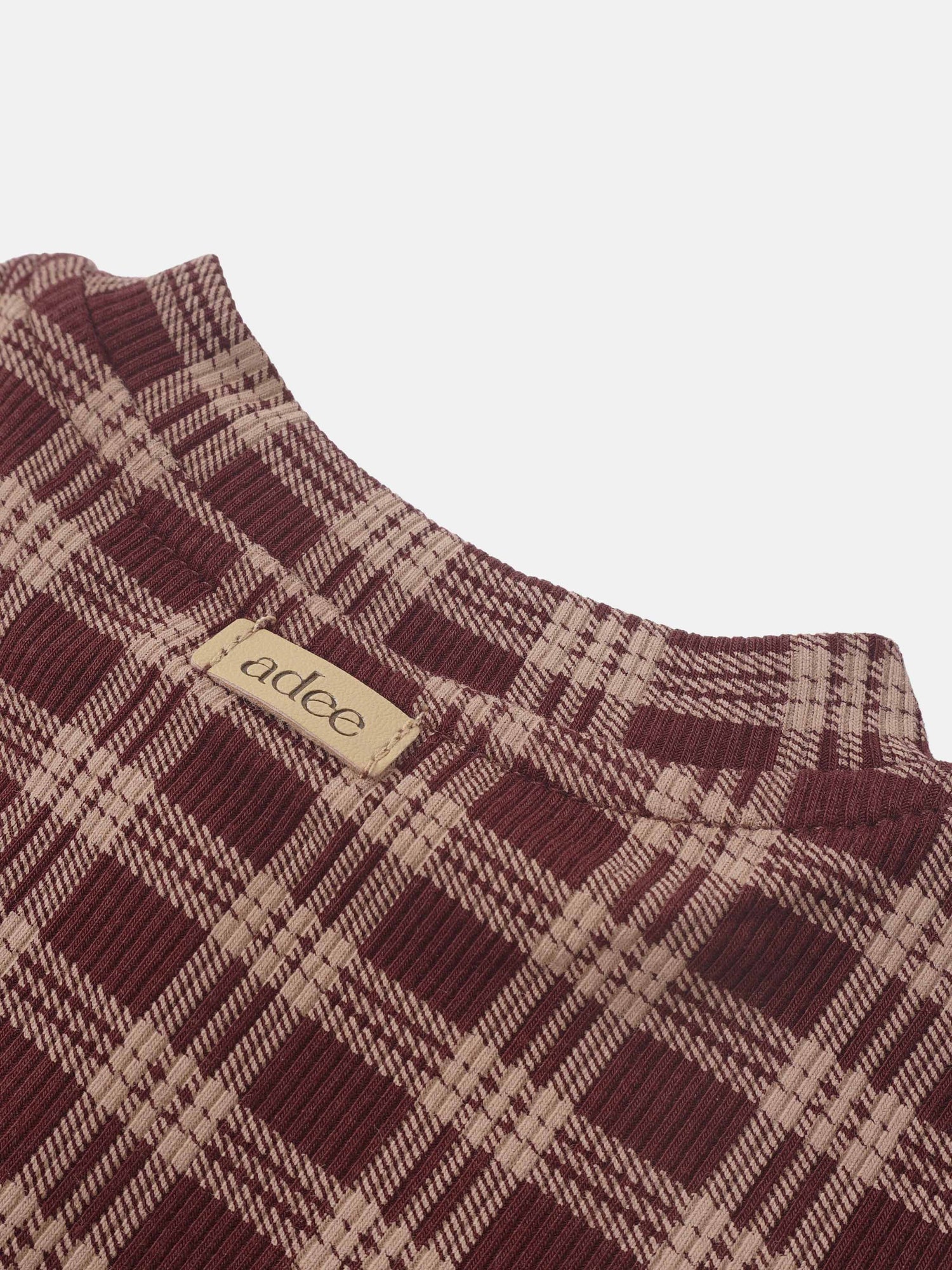 Girls Pajamas burgundy plaid by Adee, close-up of textured fabric and tag