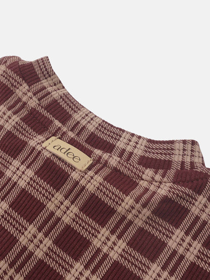 Girls Pajamas burgundy plaid by Adee, close-up of textured fabric and tag