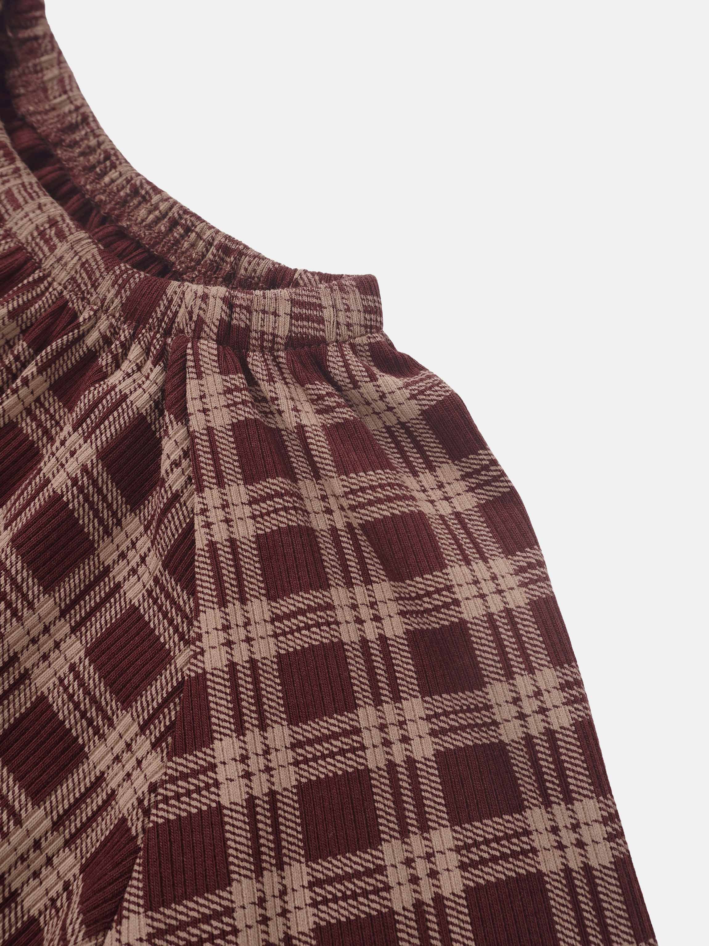 Plaid burgundy nightgown fabric close-up with elastic neckline