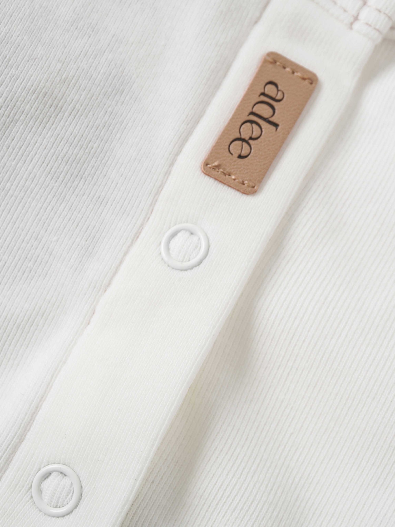 Mini Gallery Stretchy for girls; white fabric with Adee leather tag and white snap buttons