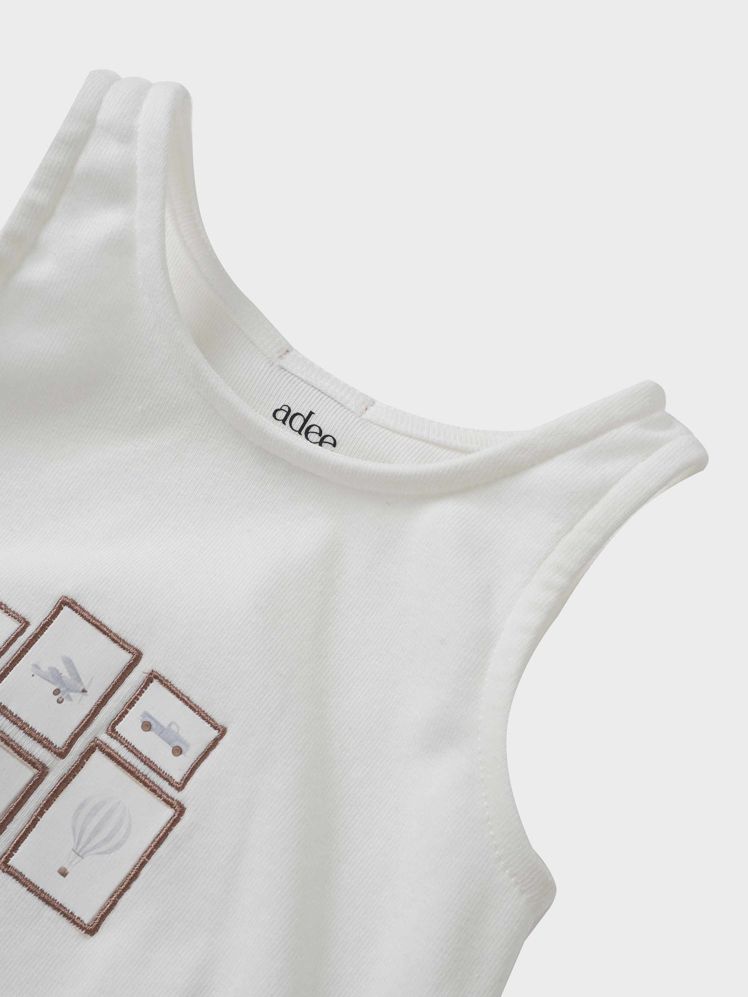 Adee Mini Gallery Romper for boys, white sleeveless romper with brown framed panels.