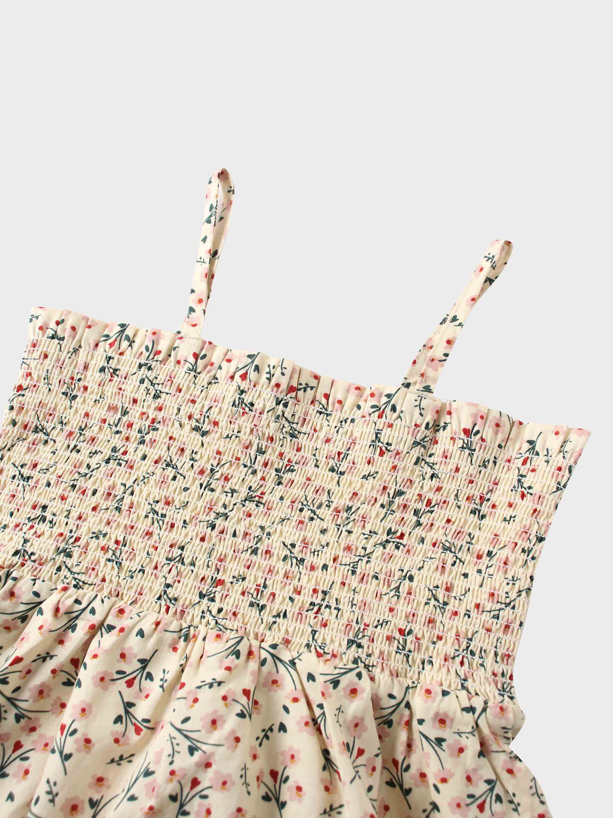 Cream floral print dress top with pink blossoms, smocked bodice, and thin adjustable straps.