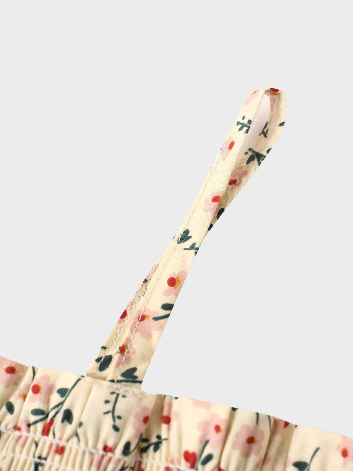 Cream background floral dress strap with pink blooms and green leaves.