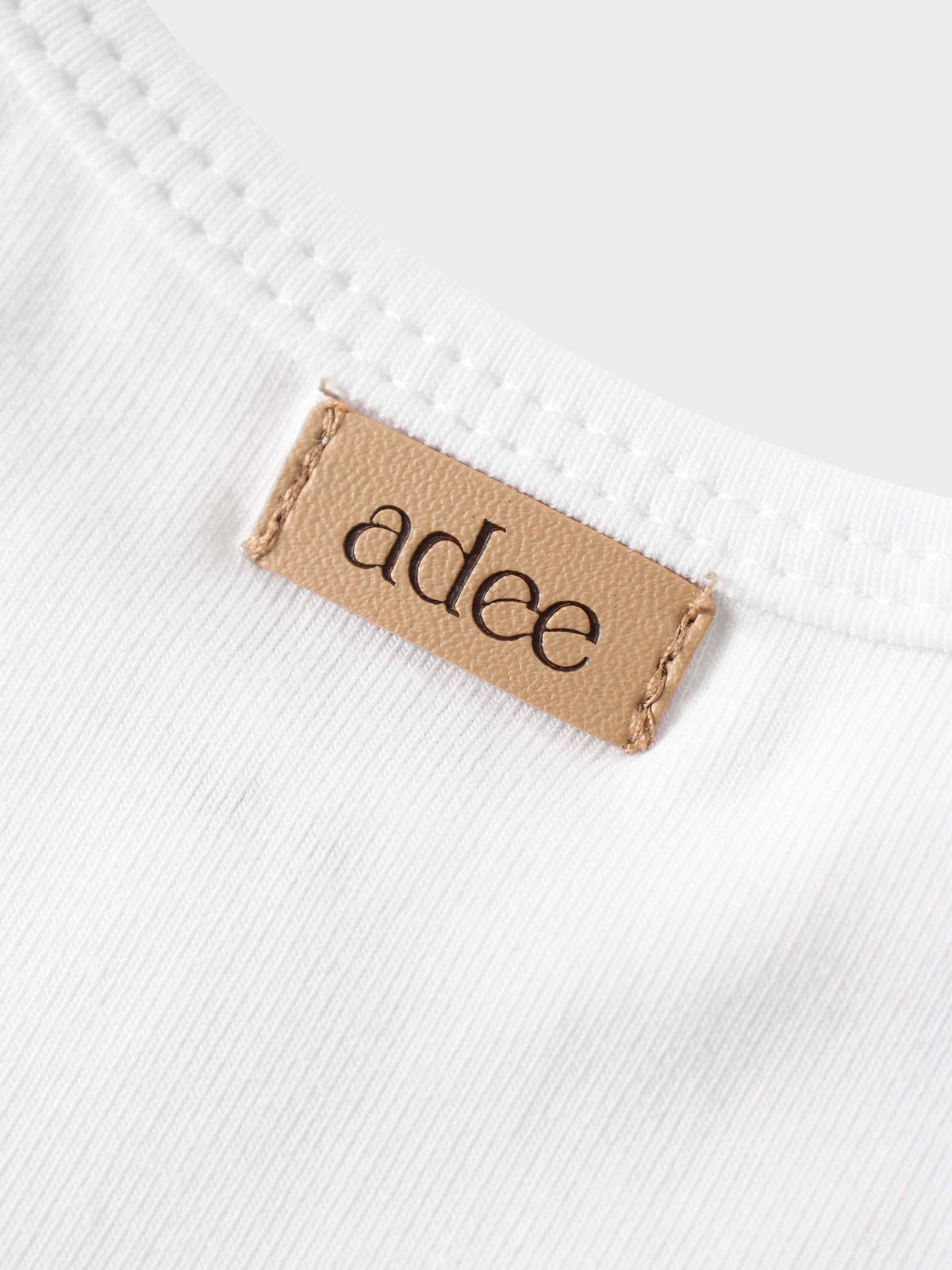 adee label on white shirt