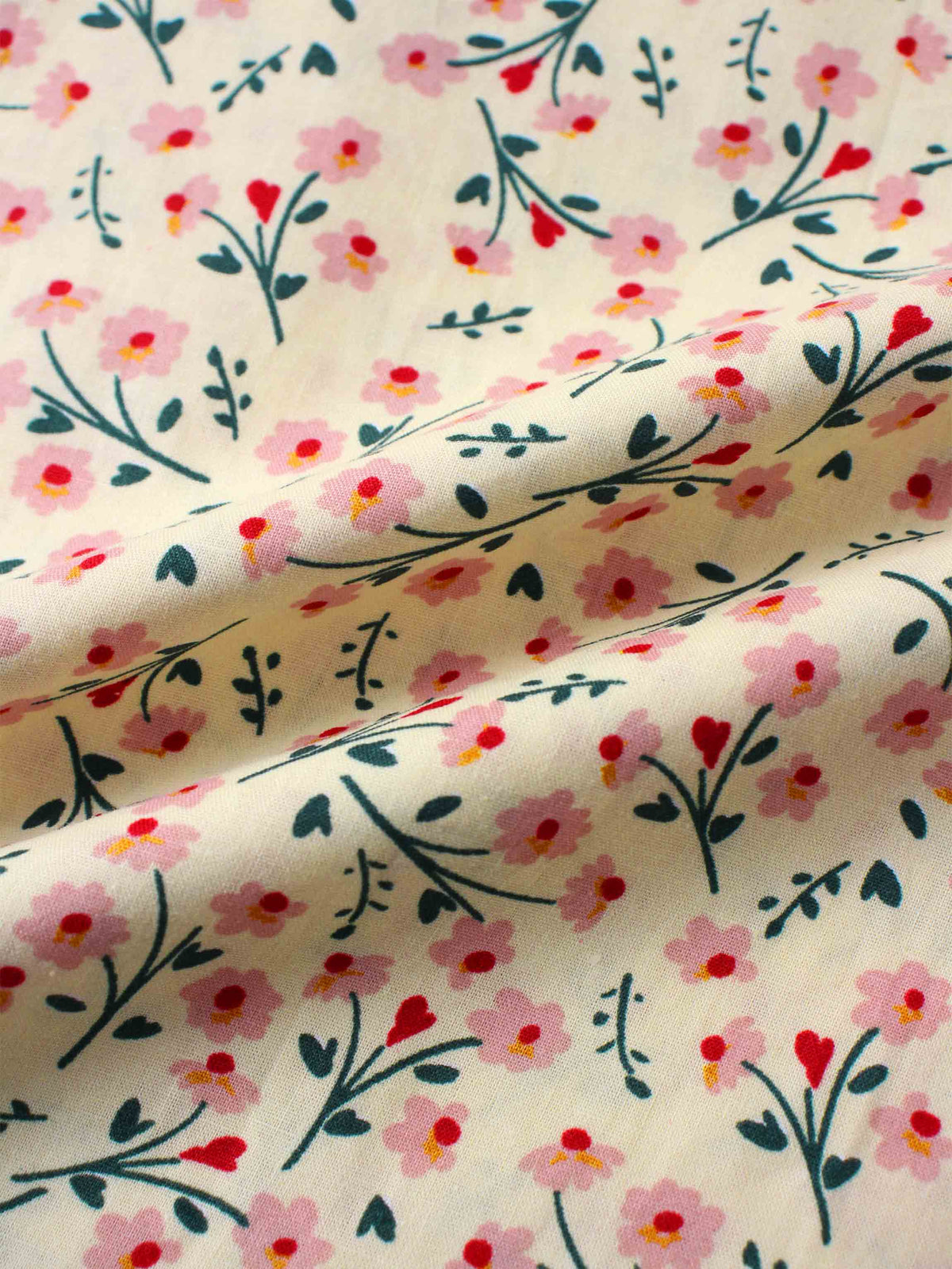 Floral print fabric on a light tan background with pink blossoms and teal stems.