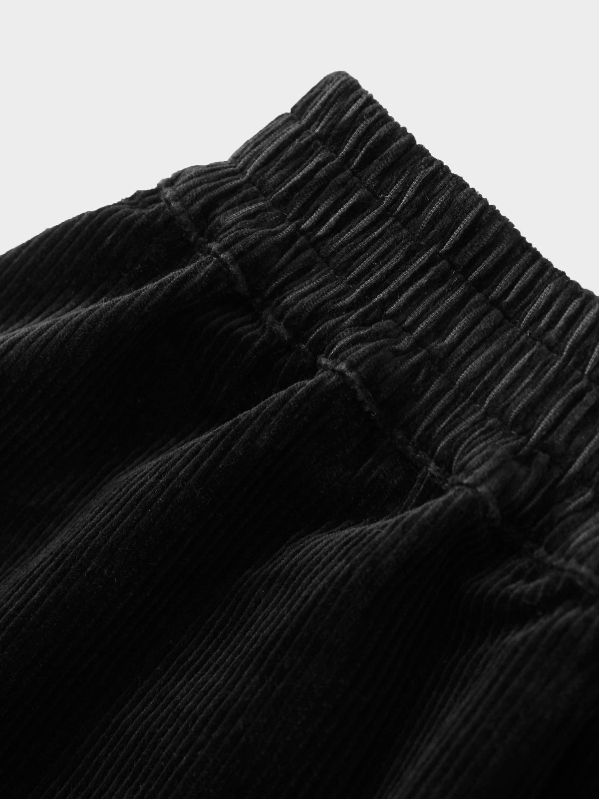 Girls black corduroy skirt with an elastic waistband; textured fabric highlights the corduroy ridges.