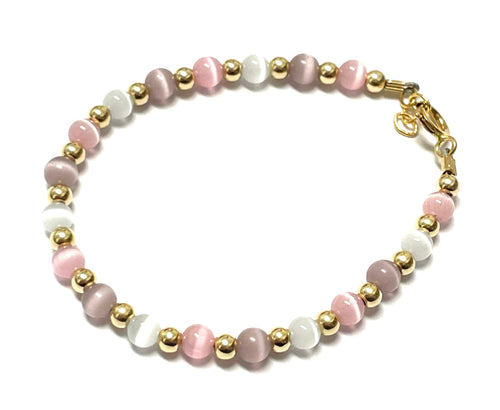Beaded bracelet in pastel pink, white, and lavender with gold spacers and a gold clasp.