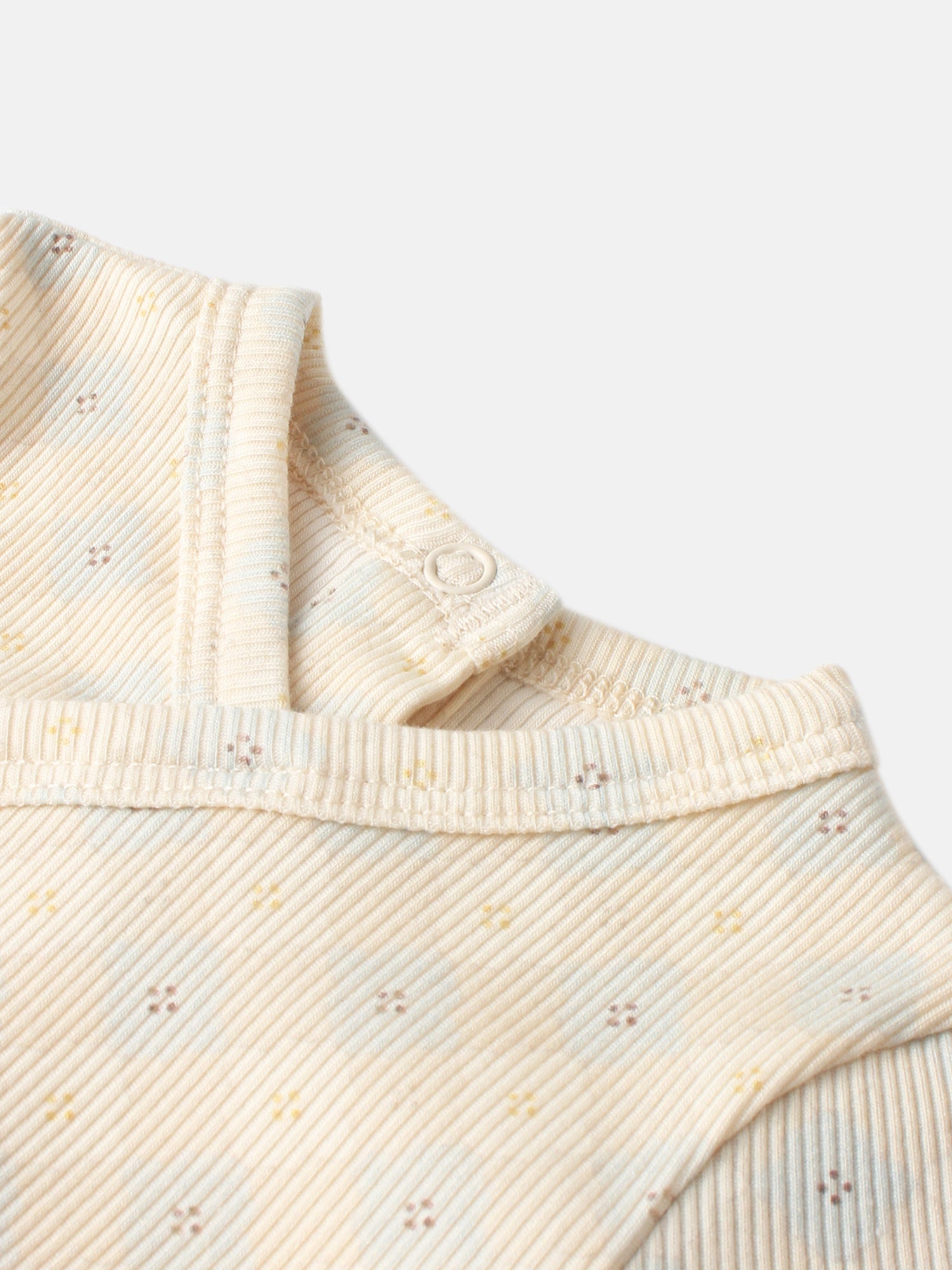 Little Button Stretchy boys top by Adee; beige ribbed knit with tiny specks and a snap button.