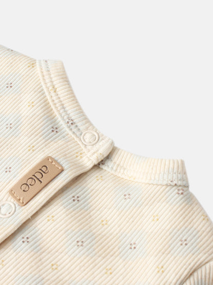 Little Button Stretchy - Blue by Adee; cream ribbed fabric with a small dotted pattern and a white snap.
