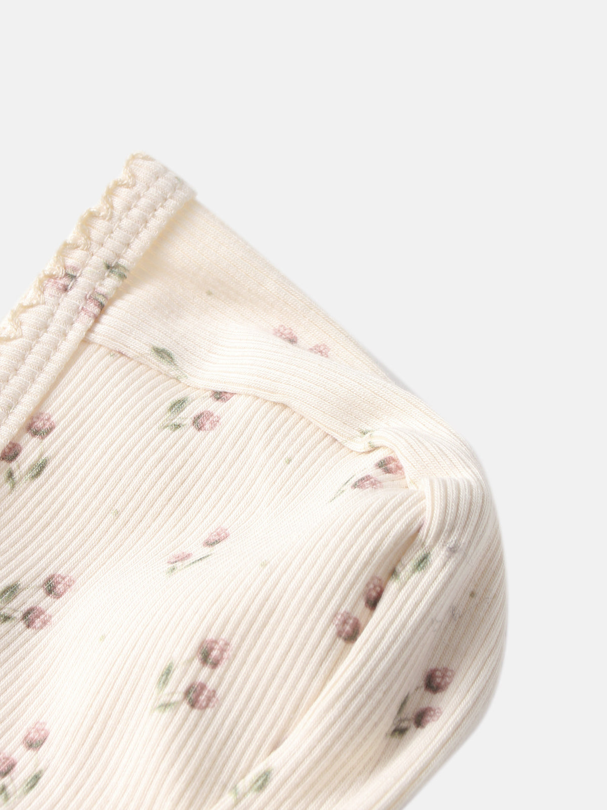 Tiny Tulip Bonnet by Adee; cream girls’ knit bonnet with pink floral print and ribbed edge.