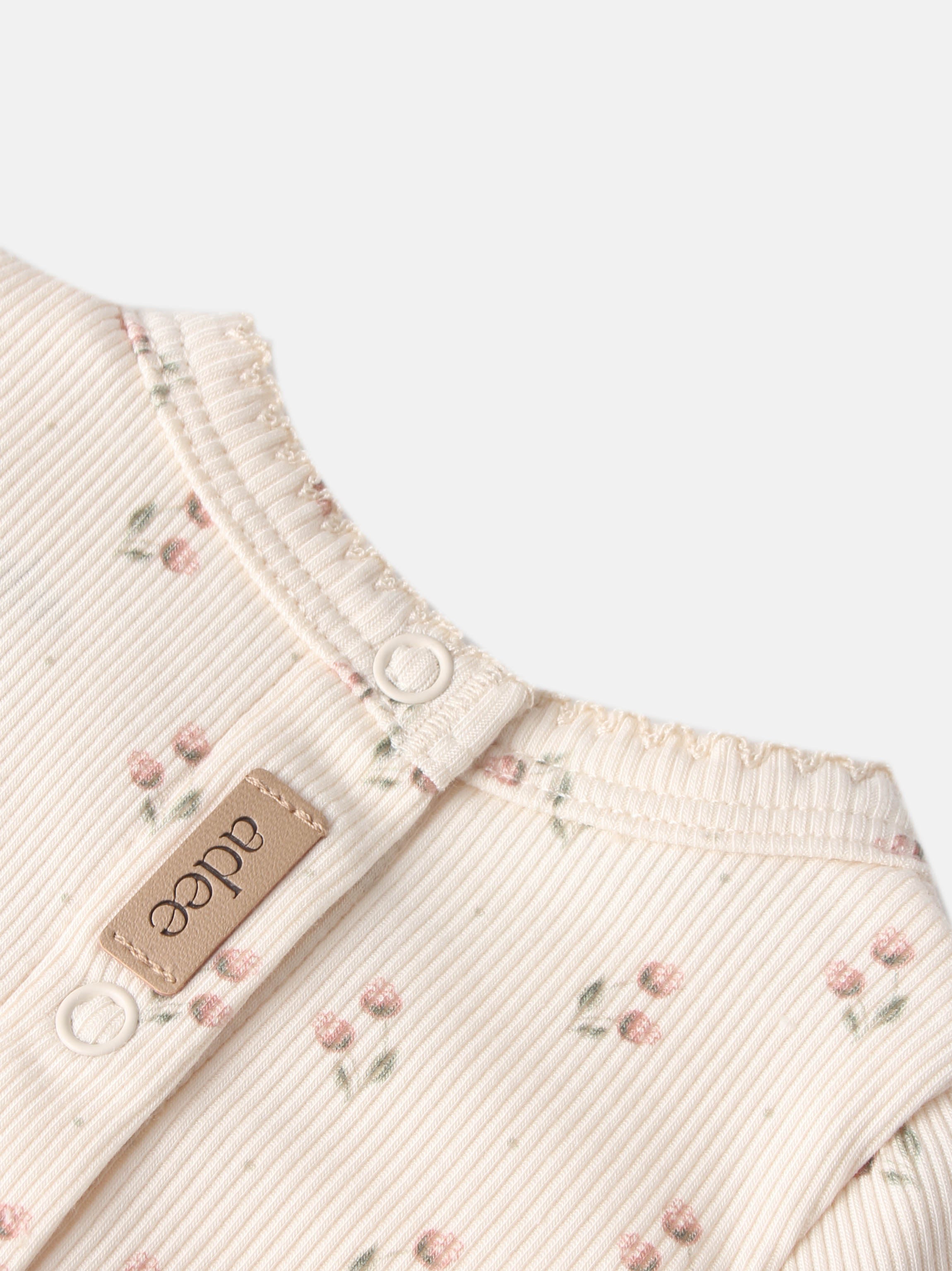 Adee Tiny Tulip layette set for girls, cream ribbed fabric with pink floral print and snap buttons.
