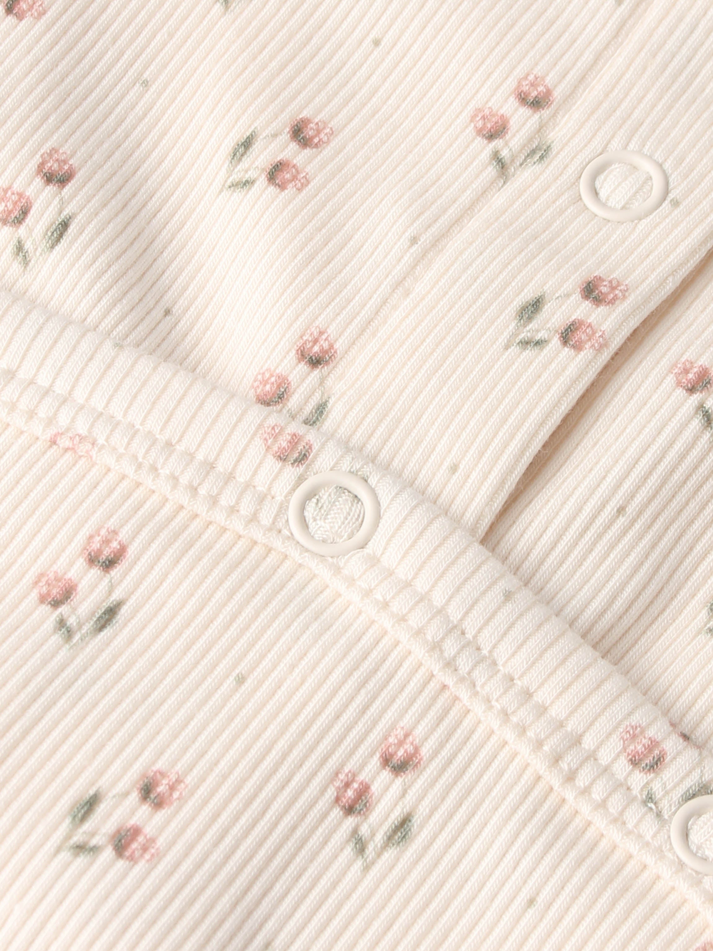 Tiny Tulip layette set by Adee; pale pink ribbed fabric with tiny pink flowers and white snap buttons.