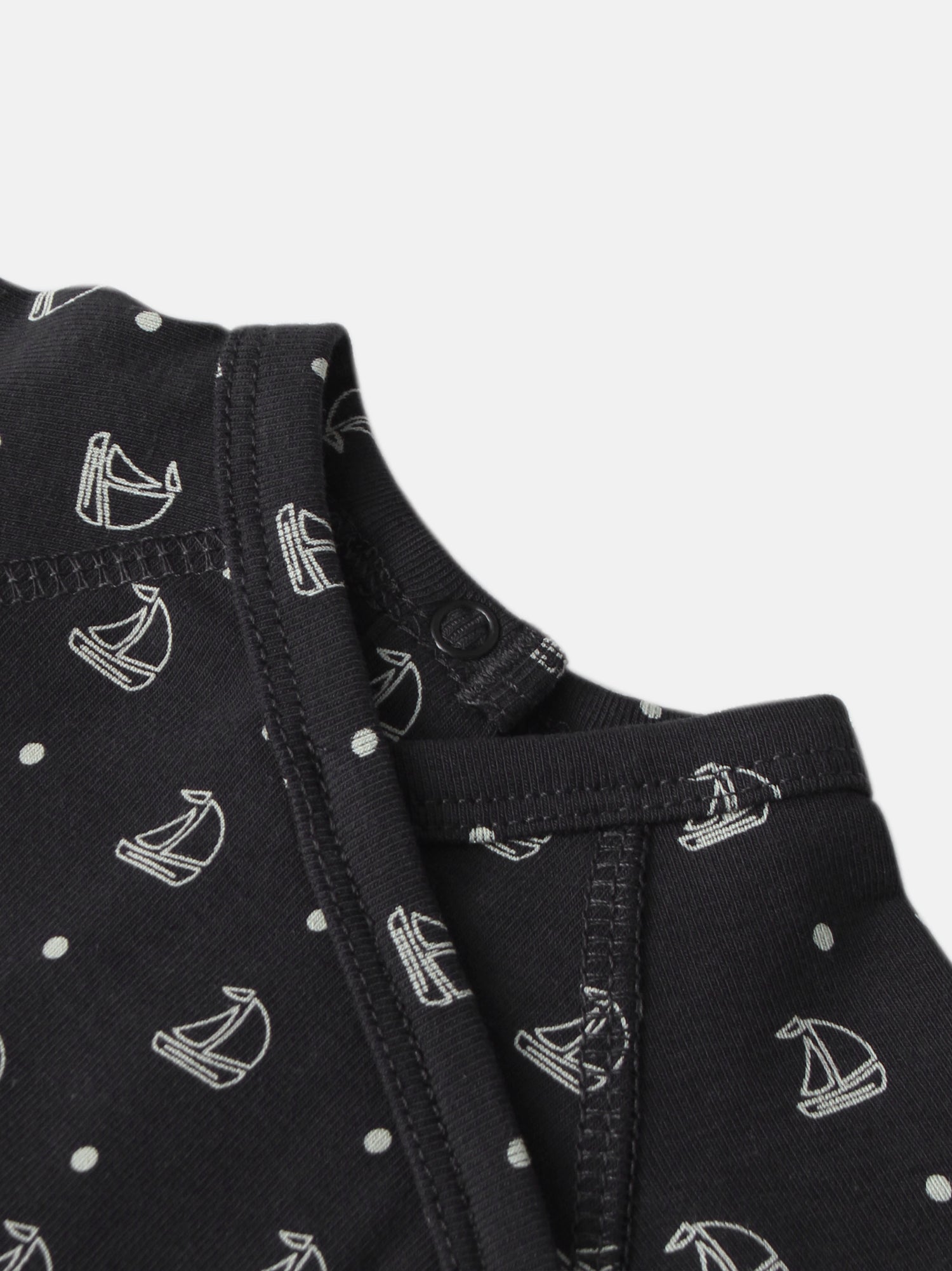 Harbor Dot layette set for boys; navy fabric with white sailboats and polka-dot pattern, close-up stitching.