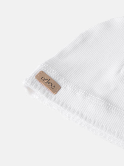 Legacy Stitch White layette set, unisex Adee brand in ribbed cotton with tan label.